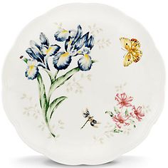 a white plate with flowers and butterflies on it