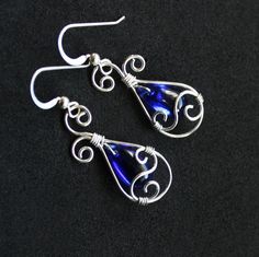 "Graceful and elegant teardrop earrings are handcrafted with beautiful royal blue glass briolettes and 1/10 silver-filled wire. Earrings dangle from comfortable silver-filled French hook ear wires. Please see second to last photo for earring measurements. Ships nicely gift boxed as shown in last photo, perfectly ready to treat yourself or a special someone. *Sterling silver-filled wire consists of a thick layer of sterling (30x thicker than any silver plated wire) bonded to a white brass core. I Wire Wrapped Teardrop Earrings For Party, Blue Sterling Silver Teardrop Pierced Earrings, Blue Briolette Teardrop Earrings For Gift, Blue Briolette Wire Wrapped Earrings, Elegant Nickel-free Czech Glass Teardrop Earrings, Elegant Blue Silver-plated Earrings, Blue Nickel-free Teardrop Earrings, Nickel-free Blue Teardrop Earrings, Nickel-free Czech Glass Teardrop Earrings As Gift