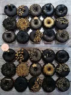 two trays filled with different types of donuts