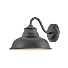 an outdoor wall light with a black shade on the side and a white back ground