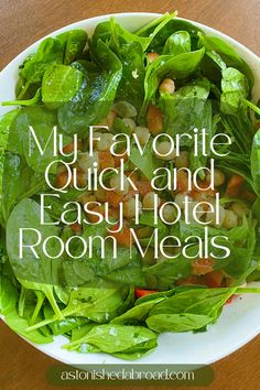 a white bowl filled with green salad on top of a wooden table