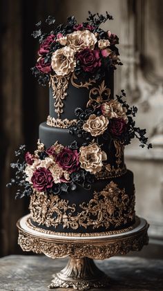 a black and gold wedding cake decorated with flowers