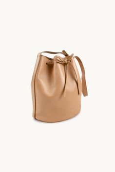 The Anne Leather Bucket Bag in almond is a stylish and versatile accessory that is perfect for any occasion. Crafted from soft 100% leather, this bag is both durable and luxurious. With its spacious interior and adjustable strap, it offers plenty of room for all your essentials while providing comfort and convenience. The almond color adds a touch of elegance to any outfit, making it a must-have accessory now and for many seasons to come.Made in Portugal.The nobility of leather is related to its Classic Beige Bucket Bag For On-the-go, Versatile Cognac Shoulder Bag With Smooth Grain, Cognac Smooth Grain Versatile Shoulder Bag, Versatile Cognac Bag With Smooth Grain, Elegant Cognac Bucket Bag For On-the-go, Versatile Smooth Grain Crossbody Bucket Bag, Versatile Smooth Grain Hobo Bag For Travel, Versatile On-the-go Shoulder Bag With Smooth Grain, Versatile Everyday Bucket Bag With Leather Lining