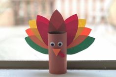 a paper roll turkey sitting on top of a window sill