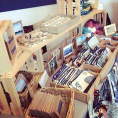 baskets and other items are on display in a room filled with wooden shelves, wicker baskets, and pictures