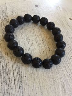 "Lava Rock beaded bracelet, 8mm beads, elastic Average bracelet size for women in 7\" and for men 8\" printable ruler - https://printable-ruler.net/ Add 1/4 inch to 1 inch (average is 1/2 inch) to your wrist size, depending on whether you would like a snug, comfort, or loose fit. Unisex Jewelry LAVA ROCK BEADS Since lava is known for its grounding qualities, it's wonderful for calming the emotions. In fact, the quality of fire springs from the ground, so in terms of healing gems, this lends itse Casual Stretch Bracelet With 8mm Lava Stone Beads, Casual Hand-strung Lava Stone Beaded Bracelets, Casual Hand-strung Beaded Bracelets With Lava Stone, Casual Black Beaded Lava Stone Bracelets, Casual Black Lava Stone Beaded Bracelets, Casual Black Beads Stretch Bracelet Gift, Casual Black Beads Stretch Bracelet, Casual Lava Stone Beaded Bracelets For Everyday, Casual Lava Stone Beaded Bracelets