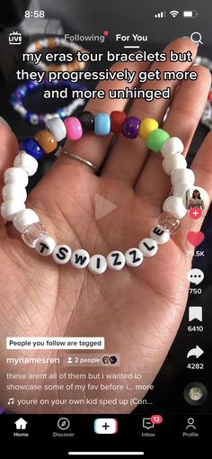 someone is holding their hand with some beads on it and the words are spelled in different languages