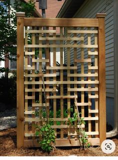 a wooden trellis in front of a house