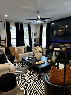 a living room filled with furniture and a flat screen tv mounted to the side of a wall