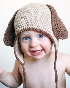 the baby is wearing a crocheted hat and smiling at the camera, while it's on sale