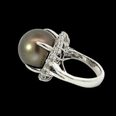 Experience the luxurious beauty of a Natural Tahitian Pearl and Diamond Ring. Captivating 1.86 ctw marquis diamonds are perfectly set to enhance its richness and sparkle. A timeless classic and unique style sure to stand the test of time. Jewelry Style : RingMetal Type : Platinum Weight : 23.18 gramsRing Size : 7.5Brand : EstateDiamond Shape : MarquiseDiamond Weight : 1.86 ctwColor : H-IClarity : SI1-SI2Stone Type : Tahitian PearlShape : RoundStone Weight : 16.7 ct Luxury Tahitian Pearl Ring For Formal Occasions, Luxury Marquise Diamond Ring With Polished Finish, Elegant Marquise Rings With Tension Setting, Elegant Marquise Diamond Ring With Polished Finish, Luxury Tahitian Pearl Wedding Rings, Time Jewelry, Pearl And Diamond Ring, Jewelry Style, Tahitian Pearls