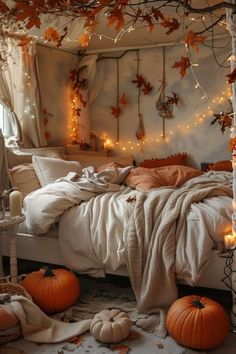 a bedroom decorated with pumpkins and lights