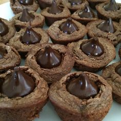 chocolate cupcakes are arranged on a white plate