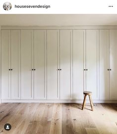 an empty room with white cupboards and wooden flooring is featured in this article