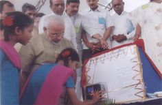 a group of men and women standing around a large sheet of paper with writing on it