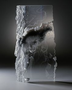 a glass block with ice and water on it's side, in the middle of an image