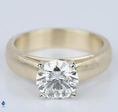 a yellow gold engagement ring with a round cut diamond