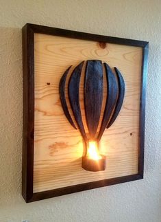 a light that is on top of a wooden frame with a hot air balloon in it