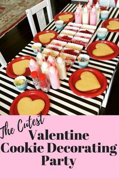 a valentine's day cookie decorating party with pink and black striped table cloth