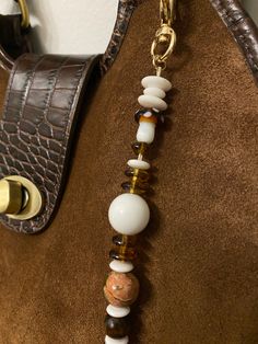 Beaded key chain that can be used as a bag charm. Handmade using brown and white beads - features brown mushroom beads. Attached to a gold lobster claw clasp. Cute Key Chains Aesthetic, Bag Charms Beads, Beaded Bag Charm, Bag Charm Ideas, Bag Charms Diy, Bag With Charms, Diy Bag Charm, Capacious Bag, Mushroom Beads