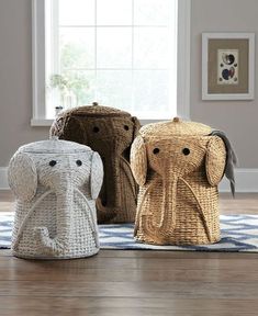 three woven elephant baskets sitting on top of a wooden floor next to a window in a living room