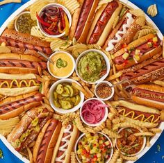 a platter filled with hot dogs and condiments