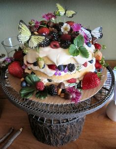 a cake with fruit and butterflies on it