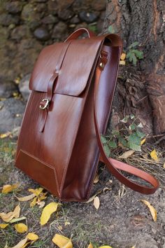 This brown leather messenger bag for men is designed to be the perfect complement for office work. Briefcase to keep your documents, Mac or laptop safe.  Can be used either as a hadbag or crossbody bag for a better confort.  Minimalist style, the same time practical and stylish. Can be customized in order to perfectly fit the dimensions of your Mac or laptop. Ideal as a gift for someone special. Office laptop bag. Business travel leather bag. This high quality leather bag is also designed to support heavy loads with adjustable leather straps. Your genuine leather briefcase has ample space inside, provide of a large interior zippered pocket to keep your pens, notebooks and iphone. Practical to quickly find your things.  Dimensions:  12.6 inches tall (32 cm) 10.2 inches wide (26 cm) 7 inches Rectangular Leather Backpack With Laptop Sleeve, Leather Briefcase With Adjustable Strap As Gift, Brown Leather Business Backpack With Laptop Sleeve, Leather Satchel Backpack With Laptop Sleeve, Office Shoulder Bag With Leather Lining In Backpack Style, Brown Leather Backpack With Laptop Sleeve For Business, Modern Brown Backpack Briefcase, Modern Brown Backpack Style Briefcase, Modern Brown Briefcase Backpack