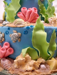 a cake decorated with sea animals and corals