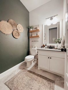 a white toilet sitting next to a bathroom sink