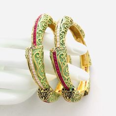 2.6 Mint Green Meenakari Kada Bangles with Ruby Semi-Precious Stone/Meenakari Bangles/Meenakari Bangles/Indian Bollywood Wedding Jewelry Features Traditional Kundan/Polki/Meenakari bangles Set Handcrafted To Perfection Light Weight Perfect For Indian Weddings And Celebrations A Beautiful & Memorable Gift for Weddings and Special Occasions The base metal color is Gold tone brass studded with colorful semi-precious stones on it. Available in 2.6 sizes Pair of two Bangles Wedding Enamel Bangle Jewelry, Traditional Gold Enamel Bangle, Ceremonial Meenakari Enamel Jewelry, Green Enamel Jewelry For Wedding, Green Enamel Wedding Jewelry, Enamel Bracelet Jewelry For Wedding, Festive Meenakari Enamel Jewelry, Multicolor Enamel Jewelry For Ceremonial Occasions, Traditional Ceremonial Enamel Jewelry