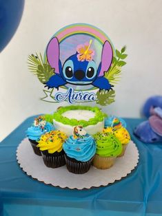 cupcakes are sitting on a table with a sign in the shape of an elephant