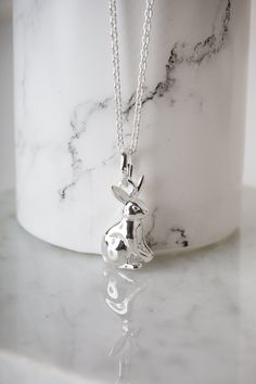 Who doesn't love a cute bunny rabbit? his is a typical emblem of our British countryside and this cute little bunny is crafted in solid sterling silver. This lovely bunny is 17mm x 8mm. This pendant is available on different length chains of adjustable chains.  The model is wearing the 40-46cm chain on the middle option. Free UK Shipping. All Gemma J pieces come with their own luxurious branded Gemma J presentation pouch. Our pouches are perfect for keeping your original pieces safe. Gemma J are an established Surrey-based jewellery brand who create designs around their passion for a love of life in the great outdoors. Every Gemma J piece is stamped with our signature shortened logo. Please follow the link below to see all items available in our Etsy shop https://www.etsy.com/uk/shop/Gemma Silver Bunny Design Jewelry For Gifts, Silver Bunny Design Jewelry Gift, Silver Jewelry With Bunny Design For Gift, Cute Bunny Rabbit, Bunny Necklace, Rabbit Pendant, British Countryside, Earrings Photo, Cute Bunny