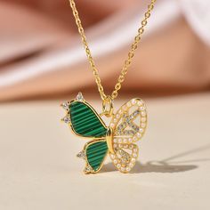 14K Gold plated Over Brass Micro Pave Dainty  Butterfly  Charm with sparkly Cubic Zirconia And Malachite Inlay. *CHAIN IS NOT INCLUDED Size: 20mm x 19mm Charm Thickness: 2.5mm Jump Ring : Open, Inside Diameter:3mm Color: Gold Bulk discount is available at drop down menu Ship from Los angeles Green Cubic Zirconia Jewelry With Rhinestones, Green Gold-plated Necklace For Anniversary, Green Butterfly Jewelry For Gifts, Green Rhinestone Jewelry For Gift, Green Butterfly Jewelry For Gift, Green Necklaces With Rhinestones As Gift, Green Rhinestone Necklace For Gift, Gold Plated Green Jeweled Jewelry, Malachite Butterfly