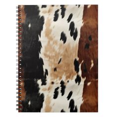 an animal print notebook with black and brown spots