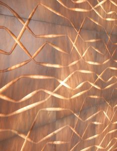 an abstract painting with lines and curves on the side of a wall in brown tones