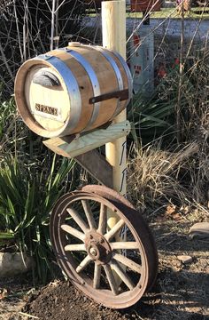 an old fashioned wooden barrel on wheels in the dirt