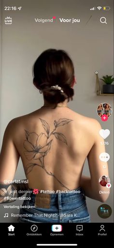 the back of a woman's body with tattoos on it