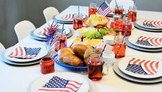 a table set with american flags and plates