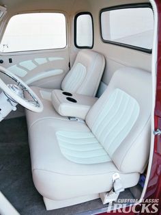 the interior of an old car with white leather seats