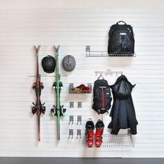 there are many skis and snowboards hanging on the wall