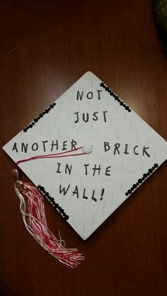 a graduation cap with writing on it that says not just another brick in the wall