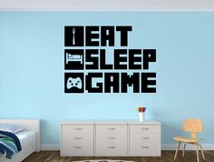 a bedroom with a bed, dresser and wall decal that says eat sleep mine