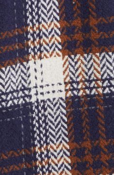 an orange and blue checkered fabric with white stitchs