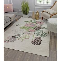 a white rug with flowers on it in a living room