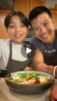 two people sitting at a table with a plate of food in front of them and smiling