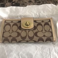 Signature Coach Brown C Wallet With Gold Trim. Turn Closure And In Back Button Closure. Never Used To Still Has Tags. Minor Mark On The Left Hand Side. Opens Up With Several Card Slots As Well. Coach Gold Wallet For Everyday Use, Coach Gold Wallets For Everyday Use, Coach Gold Wallets For Daily Use, Coach Gold Wallet For Daily Use, Gold Coach Wallets For Daily Use, Gold Coach Wallet, Coach Gold Leather Wallet, Coach Wallets With Snap Closure For Daily Use, Coach Wallet With Snap Closure For Everyday Use