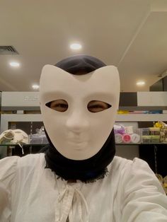 a person wearing a white mask in a store