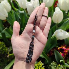 This unique necklace is perfect for anyone who loves a witchy and mystical aesthetic. The necklace is in the shape of a broom pendant, 100% handmade from different crystals:  Black Tourmaline + Moonstone + Sunstone + Apatite It is made from oxidized copper that is polished to shine. The pendant comes with a black adjustable strap. Size: 12*1.5cm Looking for witchy/Halloween aesthetic pendants? check these out https://www.etsy.com/listing/1446352794/ https://www.etsy.com/listing/1571485217/ Have any questions? Be sure to message me :) Check out my Instagram profile: @bronzaii.jewelry Bohemian Black Wire Wrapped Crystal Necklaces, Black Bohemian Crystal Necklace Wire Wrapped, Bohemian Black Wire Wrapped Crystal Necklace, Magical Black Pendant Necklace, Handmade Magical Black Jewelry, Handmade Black Magical Jewelry, Mystical Handmade Black Crystal Necklaces, Handmade Mystical Black Crystal Necklace, Handmade Black Mystical Crystal Necklace