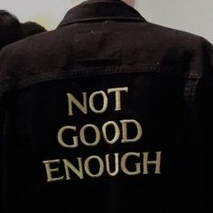 the back of a black jacket with writing on it that says, not good enough